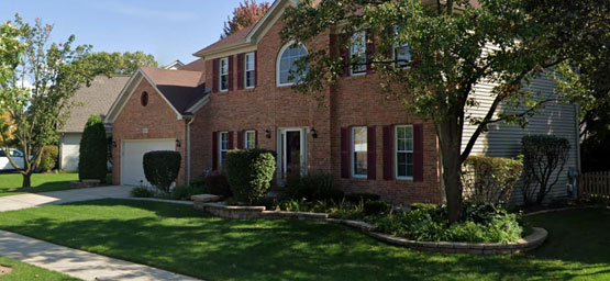 Home exterior featuring professional landscape design and lawn installation